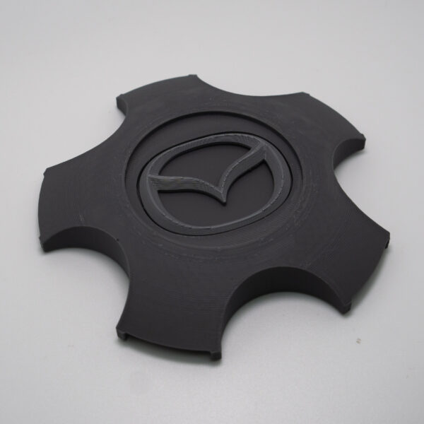 Tapabujes Mazda 6 color gris logo gris. 4 unidades